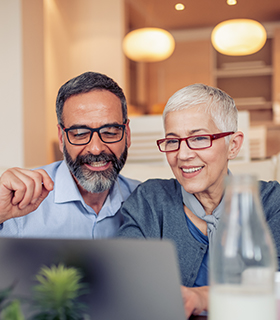 Mature couple looking at laptop