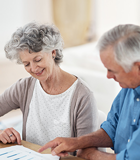 mature couple looking at paper