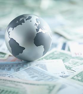 globe paperweight on money