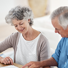mature couple looking at documents