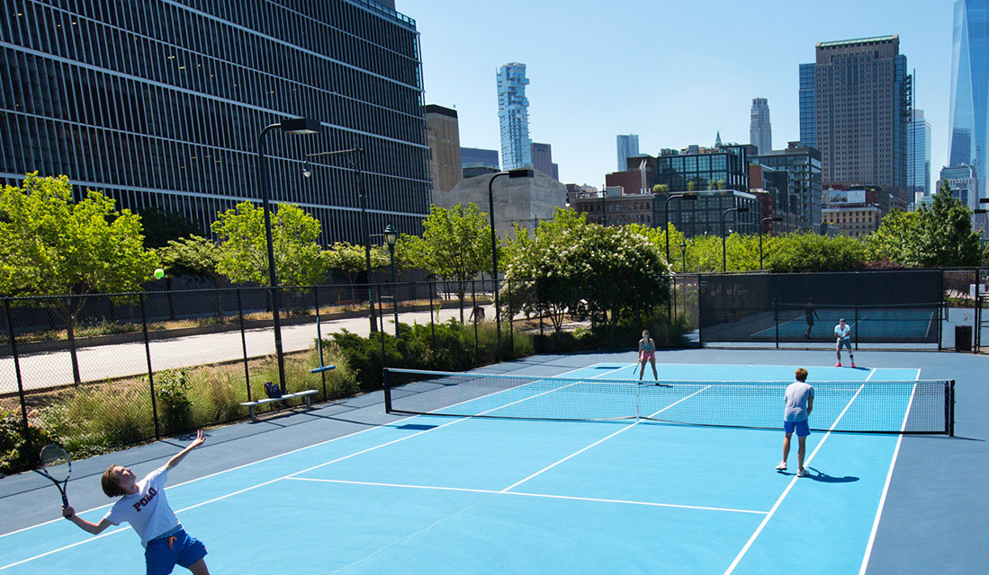 people playing tennis in the city