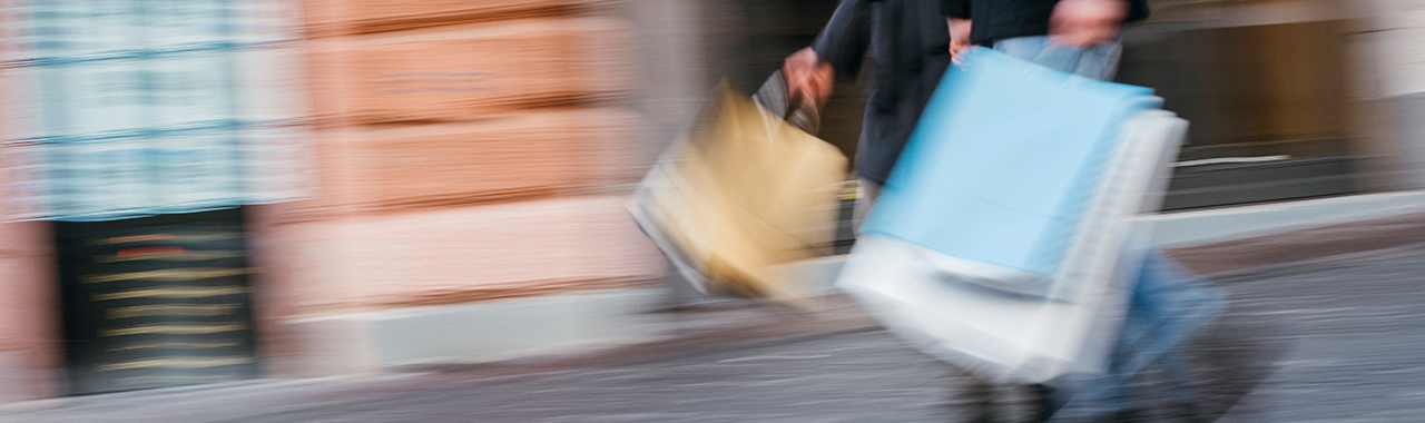 couple with shopping bags walking down the street