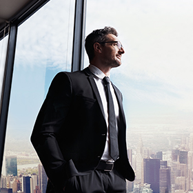 Man standing by a glass window