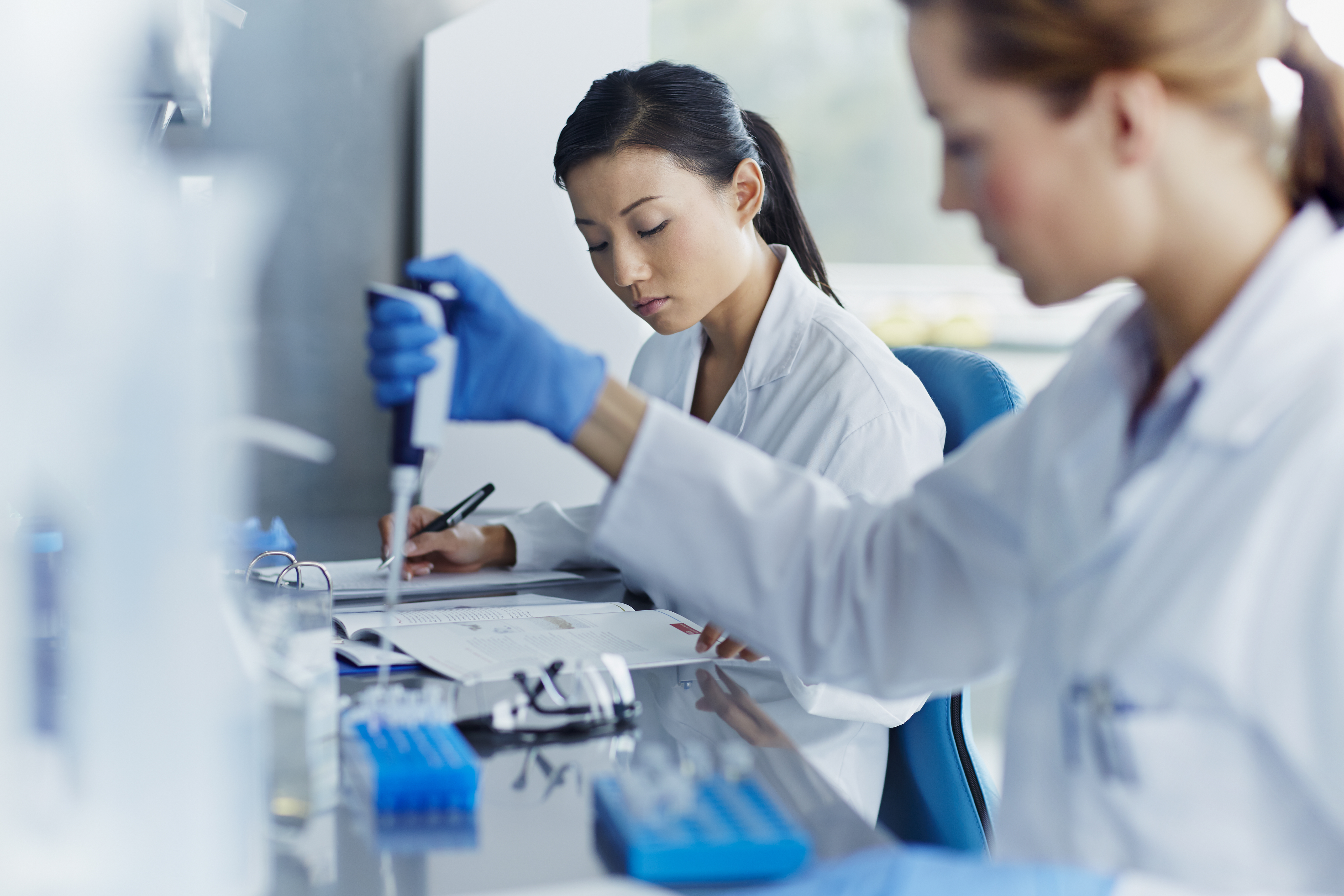 Women in a lab doing an experiment with test tubes