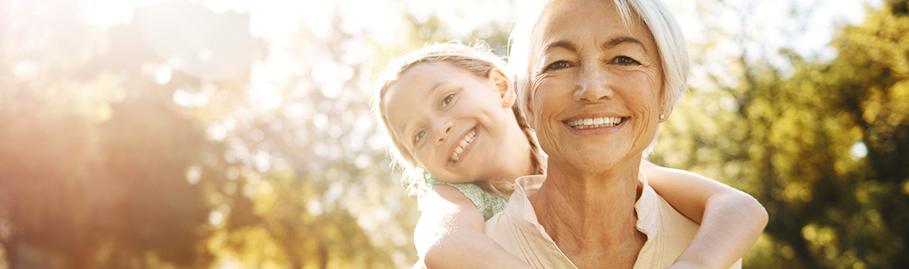 Grandmother playing with granddaughter outside