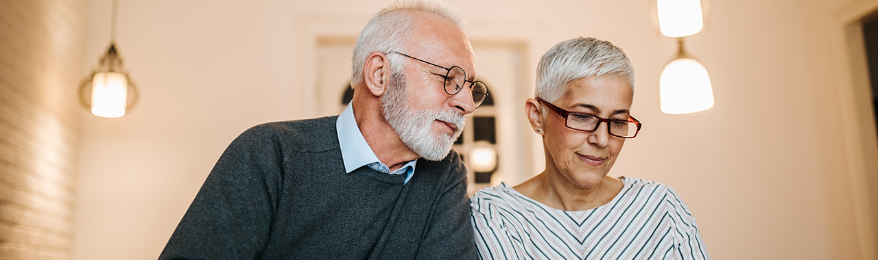 Woman and man reading financial planning documents