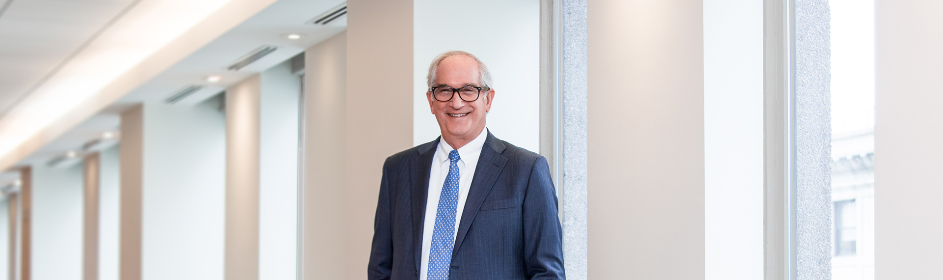 Bud Lowenthal in front of window panels