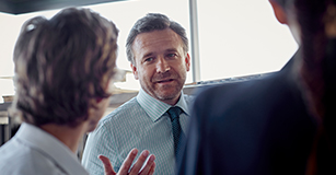 advisor speaking to two colleagues