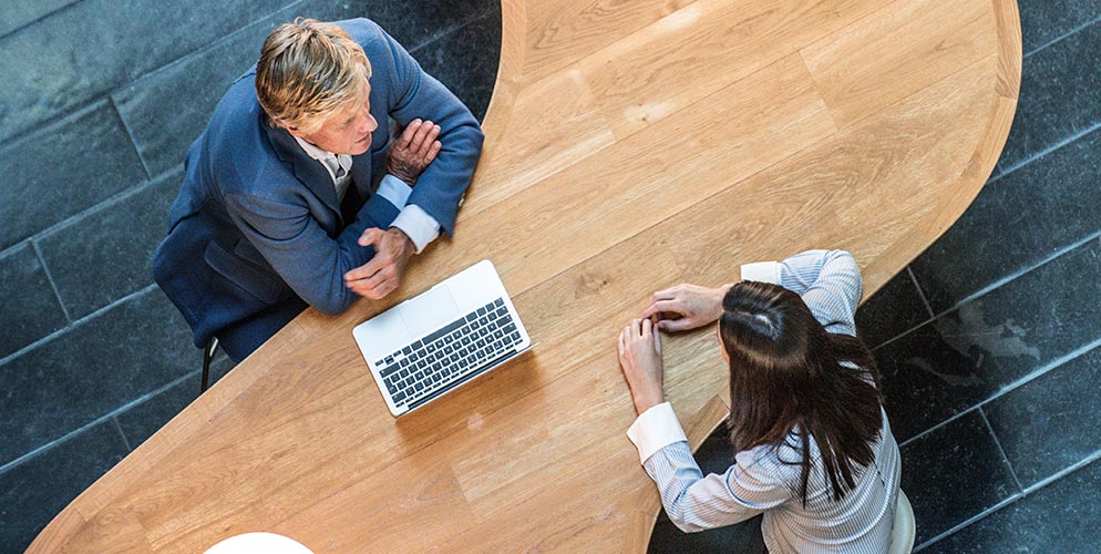 man and woman sitting at desk