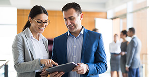 woman and man looking at tablet