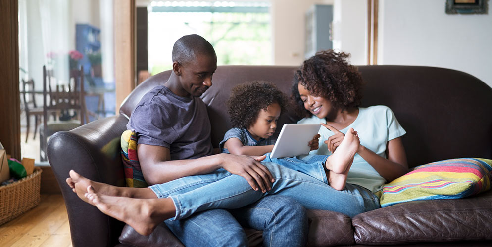 young family on sofa