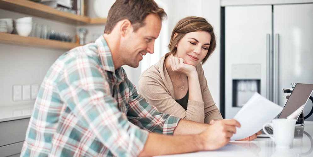 couple looking at documents in the kitchen