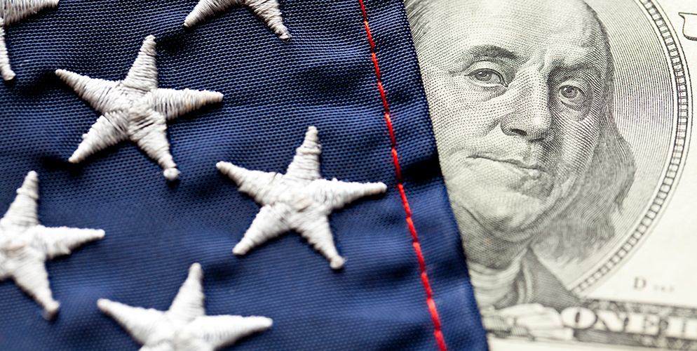 american flag and one hundred dollar bill