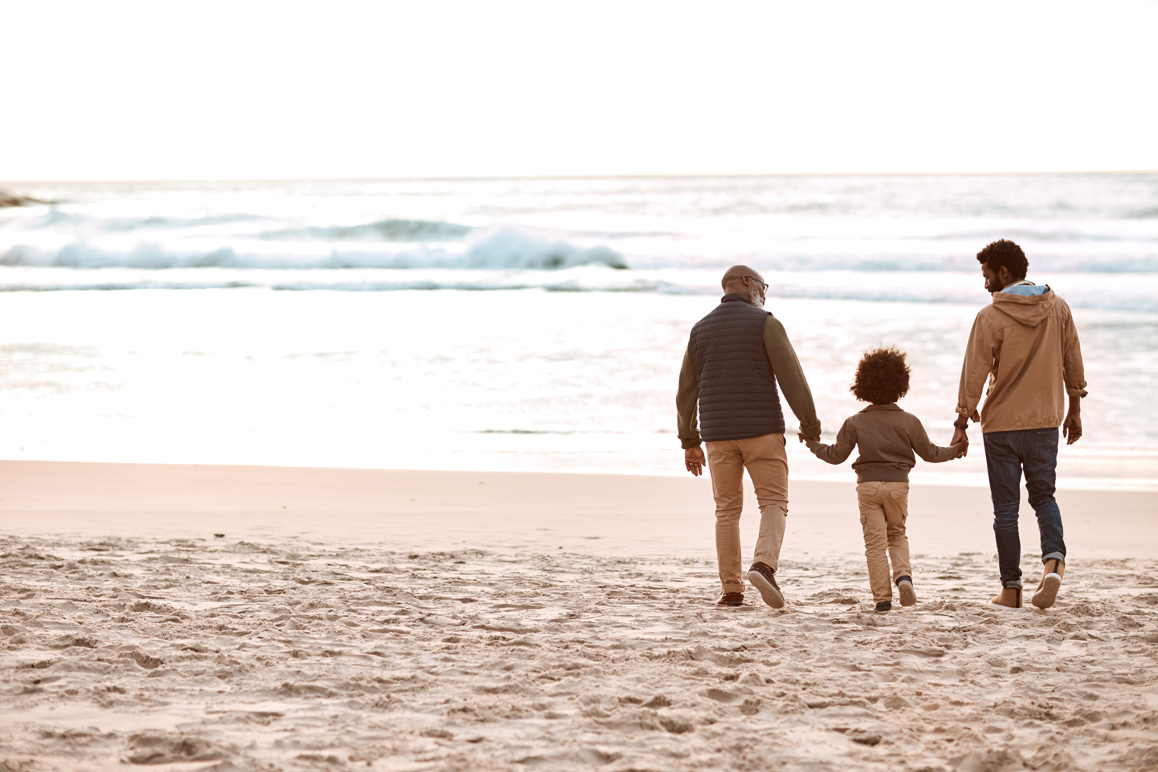 Family on beach looking at sunset.