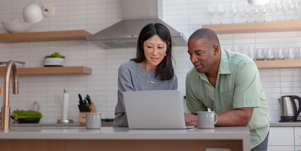 woman and man looking at computer