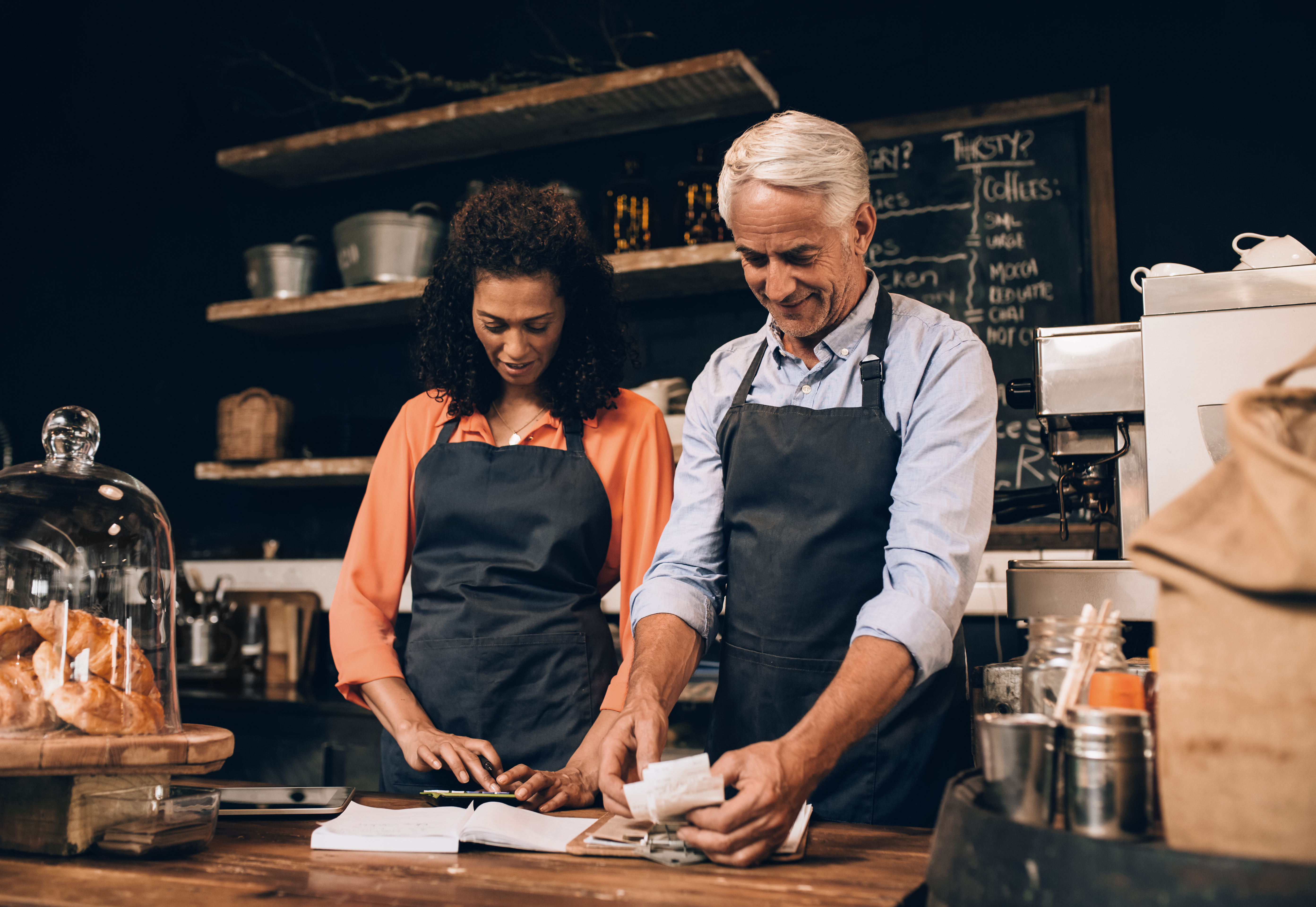 man and woman working at a counter