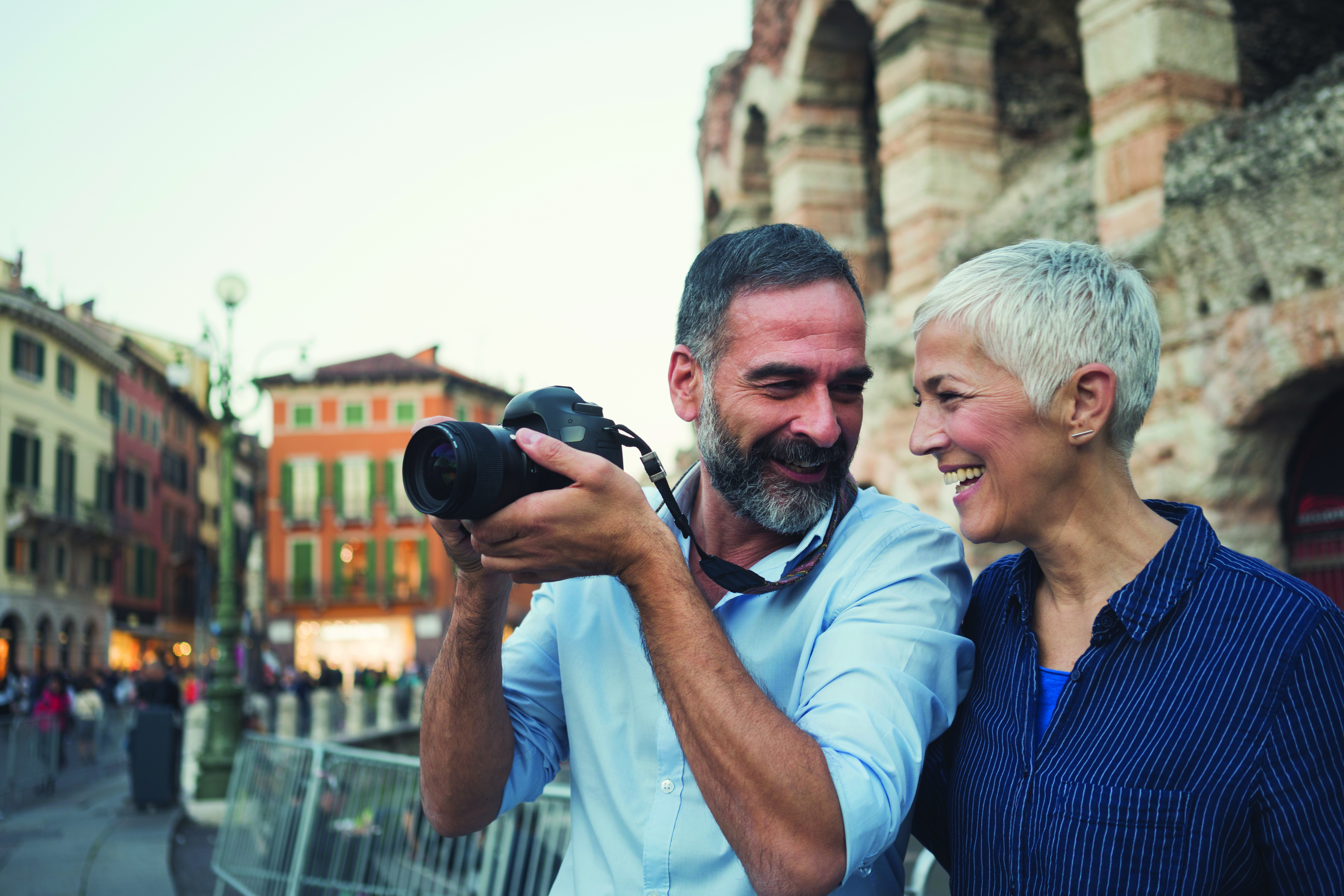 man and woman taking photograph on vacation