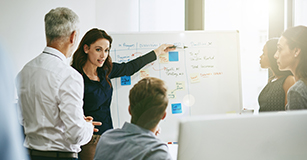 a team whiteboarding in a conference room