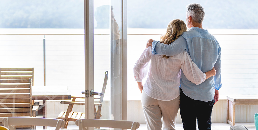 elderly couple looking out at the water