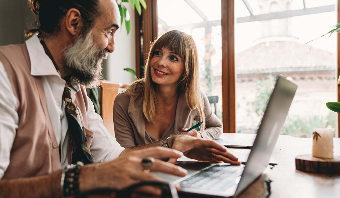 woman and man working on laptop