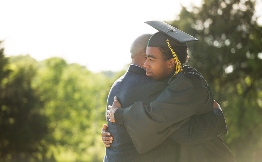 graduate hugging his parent